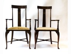 A pair of Arts and Crafts armchairs with stylised floral details - Thumbnail 1
