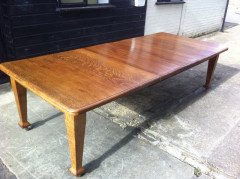 A good quality twelve seater Arts and Crafts extending oak dining table with two extra leaves. - Thumbnail 1