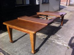 A good quality twelve seater Arts and Crafts extending oak dining table with two extra leaves. - Thumbnail 6