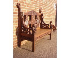 A Celtic Arts and Crafts carved oak settle with carved dragons to the tops - Thumbnail 2