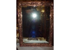 John Pearson. An Arts and Crafts copper mirror with typical hand repousse stylised floral details. - Thumbnail 1