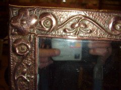 John Pearson. An Arts and Crafts copper mirror with typical hand repousse stylised floral details. - Thumbnail 2