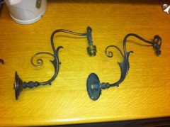 A pair of Arts and Crafts wall lights with floral leaf and scroll work decoration to the arms. - Thumbnail 1