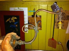 A pair of Arts and Crafts wall lights with floral leaf and scroll work decoration to the arms. - Thumbnail 4
