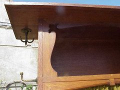 An Arts and Crafts oak hall robe with flaring cornice and twizzling coat hooks to each side - Thumbnail 3
