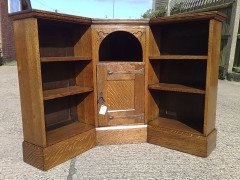 Liberty and Co. An Arts and Crafts oak corner bookcase - Thumbnail 1