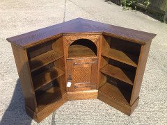 Liberty and Co. An Arts and Crafts oak corner bookcase - Thumbnail 2