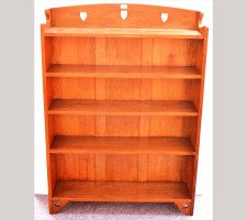 Liberty and Co. A good Arts and Crafts oak bookcase with stylised hearts to the top and to the base. - Thumbnail 1