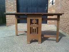 Liberty and Co. A good quality large Arts and Crafts oak drop leaf dining - Thumbnail 1