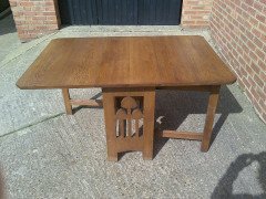 Liberty and Co. A good quality large Arts and Crafts oak drop leaf dining - Thumbnail 2
