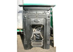 An Arts and Crafts fireplace with stylized floral details - Thumbnail 1