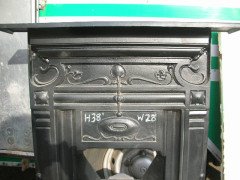 An Arts and Crafts fireplace with stylized floral details - Thumbnail 2