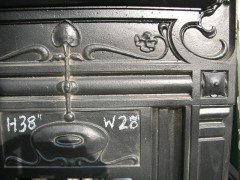 An Arts and Crafts fireplace with stylized floral details - Thumbnail 3