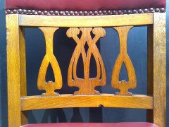 Shapland and Petter. An Arts and Crafts oak 14 seater extending dining table with three leaves and eight matching chairs - Thumbnail 16