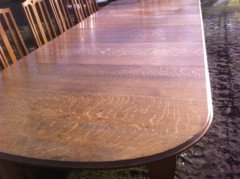 A fourteen seat Arts and Crafts oak 'D' end extending dining table with four extra leaves. - Thumbnail 4