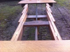 A fourteen seat Arts and Crafts oak 'D' end extending dining table with four extra leaves. - Thumbnail 6