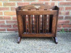 Liberty and Co. An Arts and Crafts oak Canterbury with stylised cut-outs to the ends. - Thumbnail 1