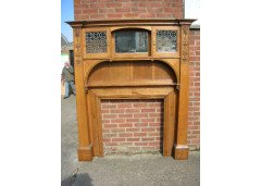 An Arts and Crafts oak fire surround with egg and dart mouldings central mirror - Thumbnail 1