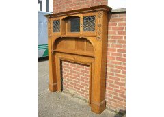 An Arts and Crafts oak fire surround with egg and dart mouldings central mirror - Thumbnail 2