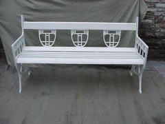 A pair of successionist cast iron garden seats with a matching four seater bench. - Thumbnail 2