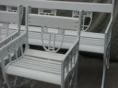 A pair of successionist cast iron garden seats with a matching four seater bench. - Thumbnail 5