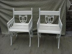 A pair of successionist cast iron garden seats with a matching four seater bench. - Thumbnail 6