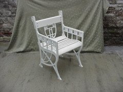 A pair of successionist cast iron garden seats with a matching four seater bench. - Thumbnail 7