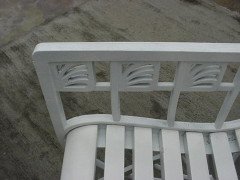 A pair of successionist cast iron garden seats with a matching four seater bench. - Thumbnail 8