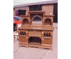 An Arts and Crafts oak sideboard with engraved copper metalwork - Thumbnail 1