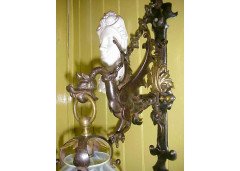 A hand wrought iron dragon wall light with original Vaseline flame shade. - Thumbnail 4