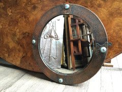 Liberty and Co (style of). An Arts and Crafts circular copper mirror inset with four turquoise and red Ruskin jewels. - Thumbnail 1
