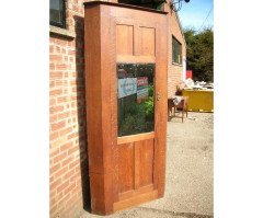 A quality tall Arts and Crafts oak cupboard with central bevelled mirror - Thumbnail 1