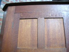 A quality tall Arts and Crafts oak cupboard with central bevelled mirror - Thumbnail 2