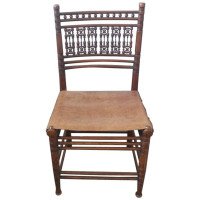 Liberty & Co. A Moorish Walnut Side Chair with Thebes Style Slung Leather Seat - Thumbnail 1
