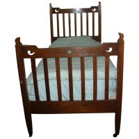 Liberty & Co., attributed. An Arts & Crafts Oak Bed with Stylized Floral Cut-Outs - Thumbnail 1