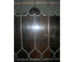 Liberty & Co. an Arts & Crafts Oak Glazed Bookcase with Stylized Heart Details - Thumbnail 7