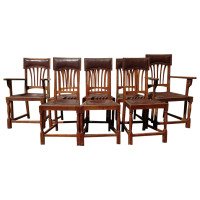 Heal's, attributed. A Set of Eight English Arts & Crafts Oak Dining Chairs