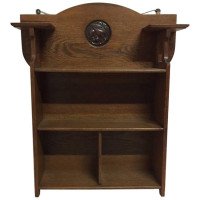 Shapland & Petter, an Arts & Crafts Hanging Oak Bookcase with Copper Plaque