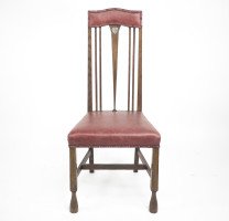 Liberty & Co., attributed. An Arts & Crafts Oak Chair with Shaped Padded Headrest & Pewter Heart Inlay