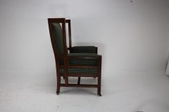 Liberty and Co, attributed, in the style of Leonard Wyburd. An Arts and Crafts oak wing back armchair - Thumbnail 5