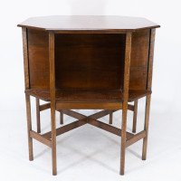 Ambrose Heals attri. An Arts & Crafts oak octagonal book table with eight legs - Thumbnail 6