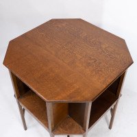 Ambrose Heals attri. An Arts & Crafts oak octagonal book table with eight legs - Thumbnail 9