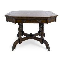 Maple & Co., A Gothic Revival Oak Leather Top Writing Table on Decorative Castors