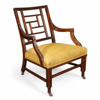 E. W. Godwin, attributed. An Anglo-Japanese Aesthetic Movement Ebonized Armchair with a Lattice Style Back