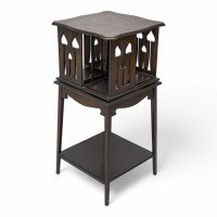 Liberty & Co., An Arts & Crafts Oak Revolving Bookcase with Stylized Floral Cut-out Decoration - Thumbnail 1
