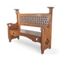 Liberty & Co., An Arts & Crafts Oak Settle with Mashrabiya Turnings to the Back