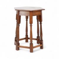 Liberty and Co. An Arts and Crafts oak side table with a hexagonal top