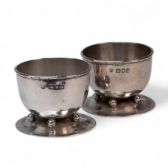 C. R. Ashbee GOH. A rare pair of Arts & Crafts hand-crafted hammered silver salts.