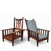 Liberty & Co., attributed. An Arts and Crafts Reclining Armchair with Carved Floral Details