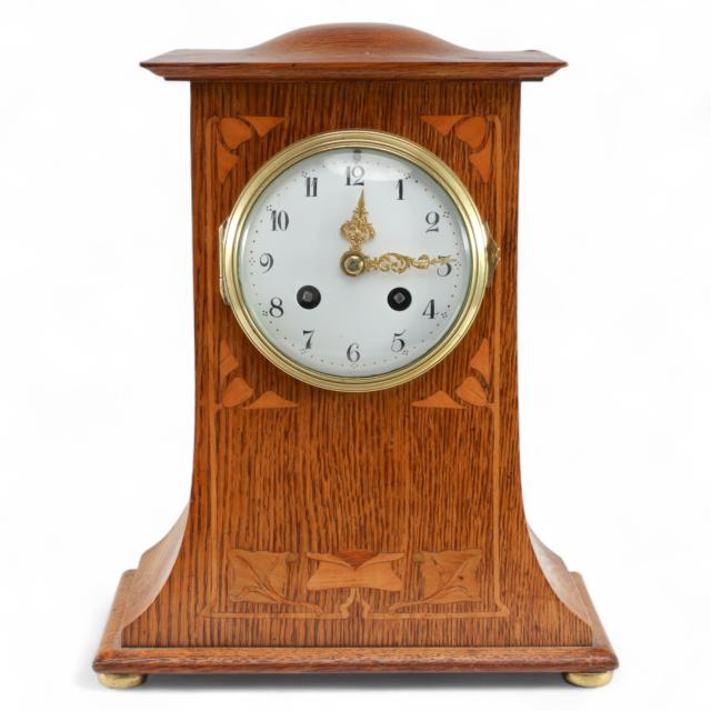 Liberty & Co., An Arts & Crafts Oak Mantle Clock with Floral Inlay
